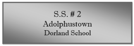 A grey rectangular sign with black text
Description automatically generated