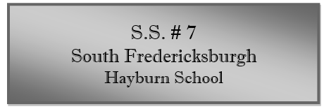 A grey rectangular sign with black text
Description automatically generated